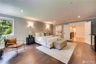 Absoutetly stunning Primary bedroom suite boasts rich hardwood flooring.