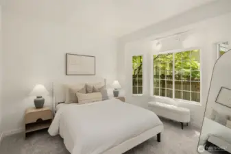 The spacious primary suite, located on the main floor, features a luxurious en-suite bath and a huge walk-in closet, offering comfort and convenience in one elegant retreat.
