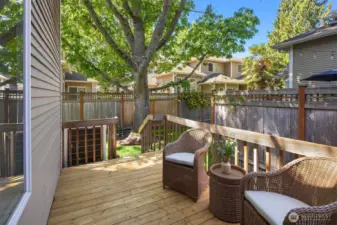 The backyard offers a calm, quiet, and serene setting with lush greenery, a charming deck, and a low-maintenance yard—perfect for relaxing or unwinding outdoors.