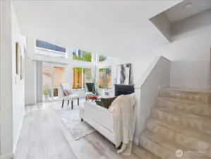 The natural light is flowing through the large windows and the vaulted ceiling in the living room gives this home an airy feel.