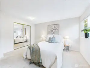 The mirrored closet doors give the illusion of the large room being even larger.