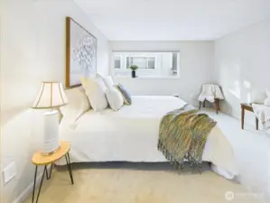 This primary bedroom is staged with a large bed.