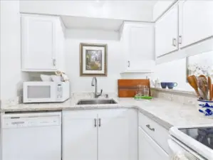 The beautiful compact white-on-white kitchen allows the cook a very efficient work flow.