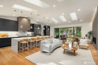Complementing the custom luxury cabinetry are premium features including a wall-mounted Vent-A-Hood, pot filler, two sinks, glass rinser, filtered water, Ketra lighting, integrated storage drawers, and Brizo designer plumbing fixtures