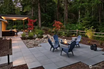 The landscape, green space, and walkways are beautifully illuminated with Lumiere outdoor lighting, offering timer functions and full color control for effortless ambiance