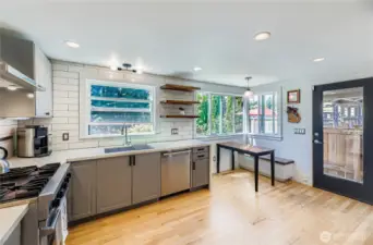 Glass door to the outside and corner windows at the eating nook bring in so much light.  Recess lighting at the ceiling complements the natural light and keeps your space bright while you create!