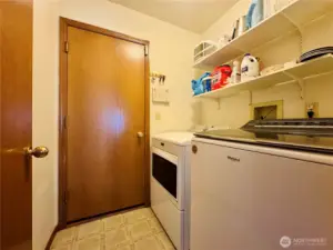 Laundry room off hallway with access to 2 car garage
