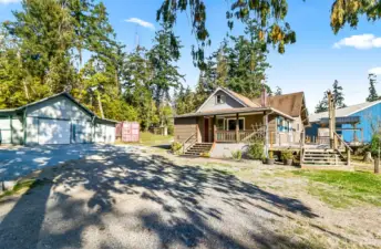 Beautiful home with lots of sun exposure, large deck on lots of acreage with a garage and sheds