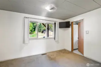 Primary bedroom with large window and en-suite