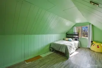 Whimsical upstairs bedroom with window and closet