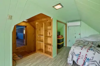 Whimsical upstairs bedroom with window and closet