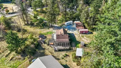 Aerial photo of property with large home, garage, sheds, ample space for RV parking, gardening, etc.