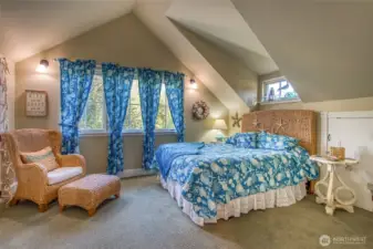This bedroom has plenty of storage with two closets and extra storage in another closet under the eaves.