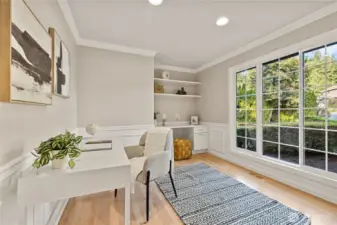 Main floor dedicated office or the perfect space for homework. Built in desk and shelves on both walls