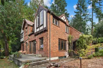 Side view of the home showing the walkway from the front door to the back patio with French doors and Sound views.