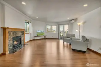 The spacious living room has a cozy gas fireplace, plenty of windows that let in the light and views of the Sound, treed area and the city. There is newer interior paint too!