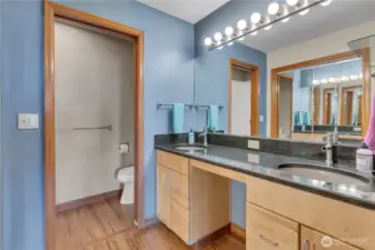 Here's a view of the primary ensuite bathroom with double sinks, granite counters, a double closet, and dual sinks.