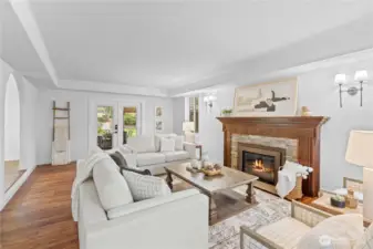 This formal living room is everything! classic fireplace, huge windows and serenity.  Outdoor living is just outside the door.