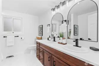 Main hall bath with dual sinks and lovely styling.