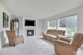 Large family room with gas fireplace & 2 big picture windows looking out to the private  backyard. Brand new carpet through out