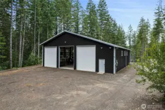 The driveway starts at the street, NE Tee Lake Road, and goes the full length of the property down to the home building site.  The driveway is meandering from the main road to obscure the view of the property from the street.