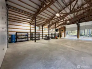 30 and 50 amp power in the garage.  Full hookups for trailer or RV. There are power outlets up high in hte corners of the garage for indoor security cameras or more garage heaters. Garage racks stay with the garage.