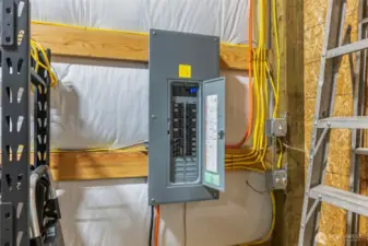 Electrical panel in the garage is 200 amp panel with multiple 30 amp outlets throughout the garage.   You can run a welder, chargers, heaters or compressor in this garage. This panel is independant from the house panel.    There is a separate panel down at the future home building site.