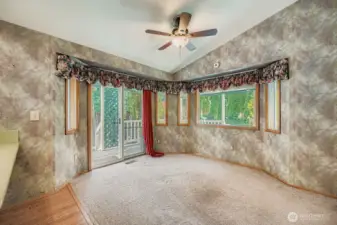 Dining room open to the kitchen and the living room. Enjoy vaulted ceilings for an even more spacious feeling. Wood wrapped windows throughout.