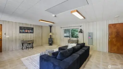 This space is warmed by a classic wood stove for year-round comfort.