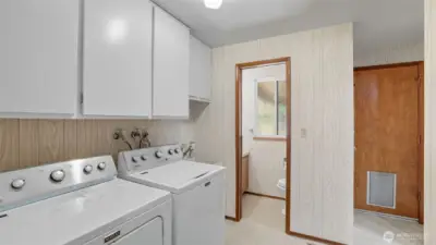 This convenient laundry space offers easy access to half bath