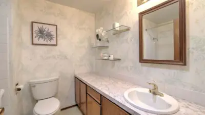 Spacious guest bathroom featuring ample vanity space and tub/shower combo.