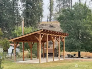 Custom built sturdy RV cover with concrete pad, thoughtfully designed for future conversion to town house or cabin.   Spacious covered structure provides shade, storage, and versatility.