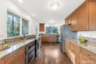 Kitchen-Looking towards the side door out to the wrap around deck- Walk-in pantry is just to the right past the fridge