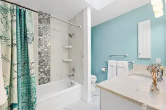 Main floor full bath- Bright and cheerful with natural light all day long. There is a built in socket in the wall cabinet to keep your electric tooth brush charged up and off the counters. (such a smart thing to do)