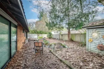 Flat backyard, shed, water feature & deck.