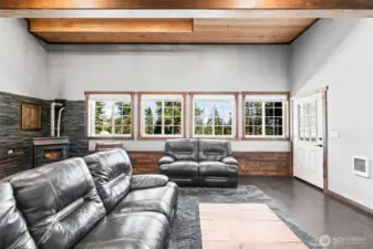 Comfortable living room with large windows bringing in natural light and views.
