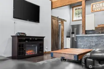 Living area with electric stove creating a warm and cozy mountain cabin feel.
