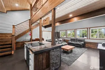 Open kitchen and great room with expansive windows bringing in natural light.