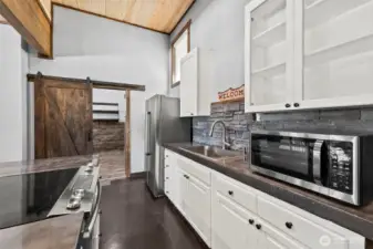 Updated kitchen with white cabinetry, modern appliances, and clean finishes.