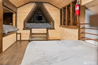 Primary Loft / sleeping area with warm wood finishes and cozy cabin feel.