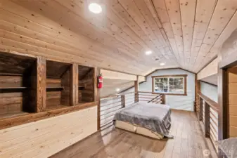 Loft bedroom with rustic wood interior and flexible sleeping space.