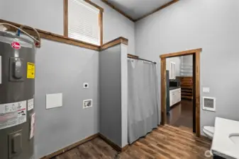 Utility and full bathroom. Shower / tub, and additional storage space.