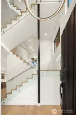 Luxurious staircase with glass railings.