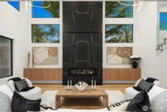 Light filled living room with 20' ceilings and gas fireplace.