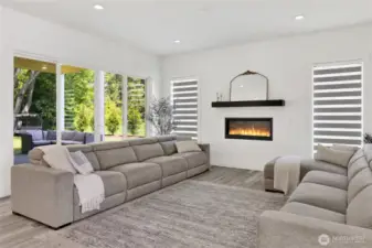 Family room with cozy fireplace and large sliding glass door to covered deck