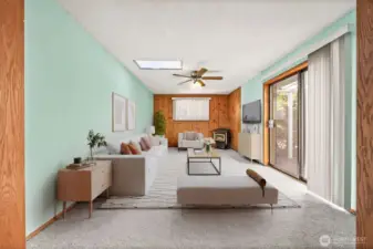 Virtually Staged. Versatile room off the dining area with a gas fireplace and sliding glass doors leading to a covered deck — perfect room for TV, home office, or entertaining space.