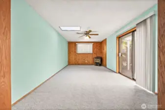 Versatile bonus room perfect for a TV lounge, playroom, or home office. Skylight adds natural light, and sliding doors lead directly to the backyard deck — ideal for indoor-outdoor living!