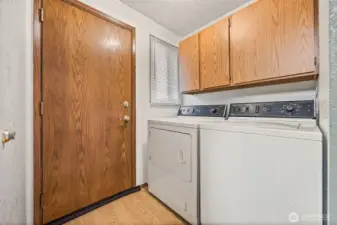 Convenient laundry area off the kitchen with direct access to the backyard deck for easy barbecues and outdoor living.