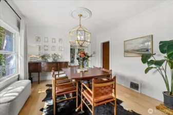 Natural light and a stunning chandelier elevate the dining space