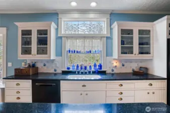 Lovely territorial views can be enjoyed while washing dishes or preparing a meal.  An expansive island enjoys a ton of storage underneath. This kitchen is light and bright and a chef's delight.